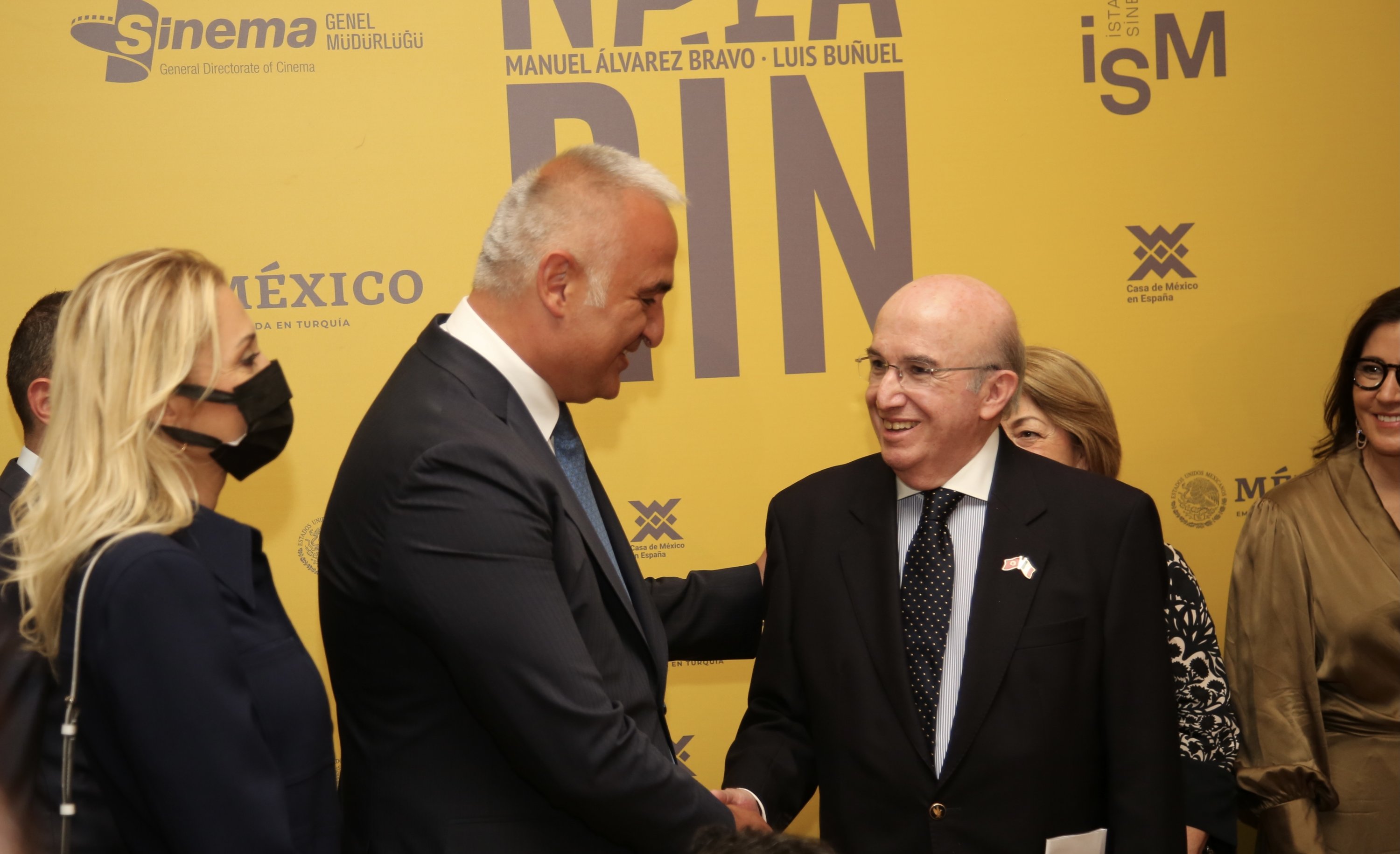 Minister of Culture and Tourism Mehmet Nuri Ersoy (L) shakes the hand of the Mexican Ambassador to Ankara Jose Luis Martinez y Hermandez at the 'Nazarin' exhibition at the Istanbul Cinema Museum, in Istanbul, Turkey, Oct. 8, 2021.
