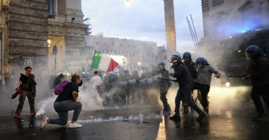 Demonstrators and police clash during a protest, in Rome, Italy, Oct. 9, 2021. (AP Photo)