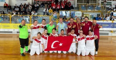 Turkey's National Futsal Team with Down Syndrome poses with the Turkish flag after beating Portugal at the Trigames in Ferrera, Italy, Oct. 10, 2021. (AA Photo)