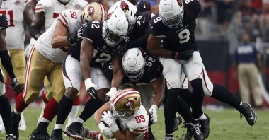 San Francisco 49ers tight end Charlie Woerner (89) is tackled by Arizona Cardinals outside linebacker Devon Kennard (42), defensive tackle Corey Peters (98) and linebacker Isaiah Simmons (9) during the second half at State Farm Stadium, Glendale, Arizona, U.S., Oct. 10, 2021. (Chris Coduto-USA TODAY Sports via Reuters)