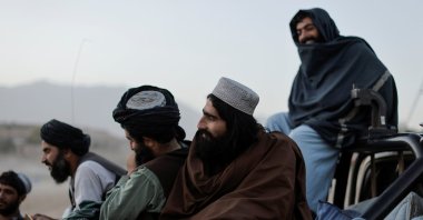 Taliban fighters sit on a vehicle as they take a day off to visit the amusement park at Kabul's Qargha reservoir, at the outskirts of Kabul, Afghanistan October 8, 2021. (Reuters Photo)