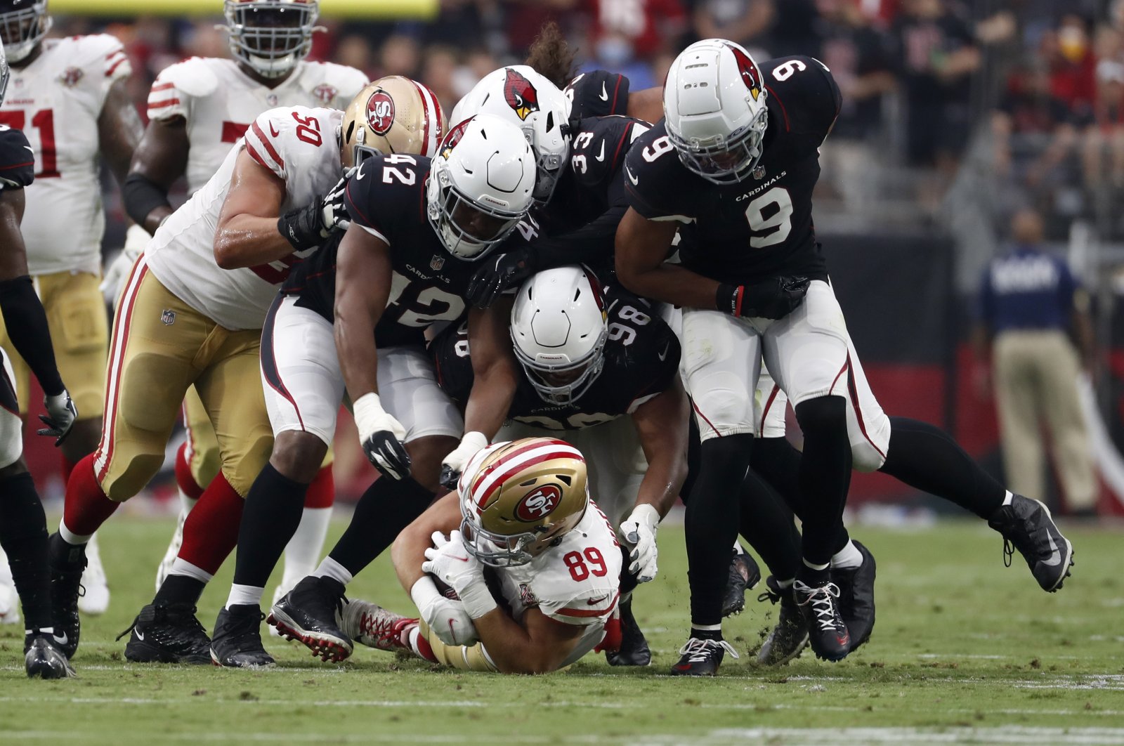 San Francisco 49ers tight end Charlie Woerner (89) is tackled by Arizona Cardinals outside linebacker Devon Kennard (42), defensive tackle Corey Peters (98) and linebacker Isaiah Simmons (9) during the second half at State Farm Stadium, Glendale, Arizona, U.S., Oct. 10, 2021. (Chris Coduto-USA TODAY Sports via Reuters)