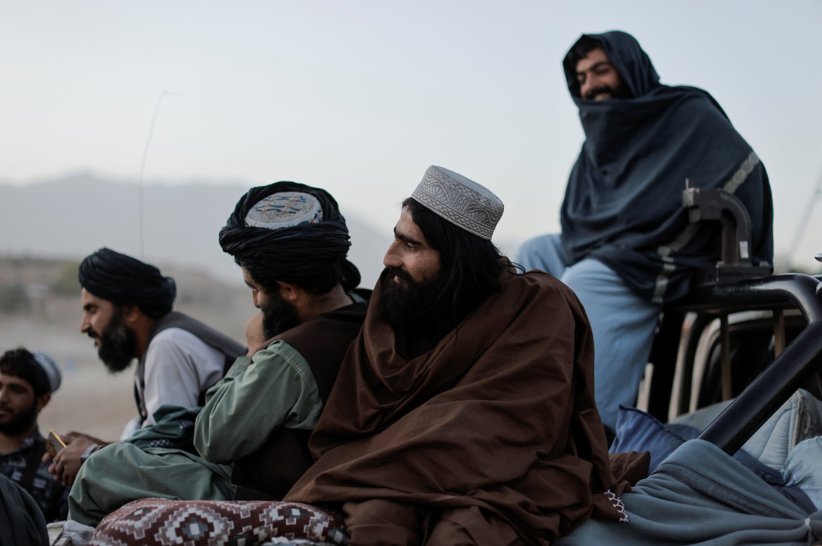 Taliban fighters sit on a vehicle as they take a day off to visit the amusement park at Kabul's Qargha reservoir, at the outskirts of Kabul, Afghanistan October 8, 2021. (Reuters Photo)