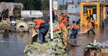 Rescue workers drain off flood waters after heavy rainfall at a flooded area in Jiexiu in the city of Jinzhong in China's northern Shanxi province on Oct. 11, 2021. (AFP Photo)