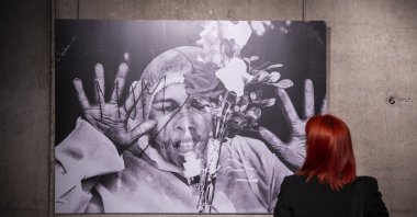 A visitor examines Mohammed Shajahan's photo titled "Mom Love," winner of the Photo of the Year Award, CerModern Arts Center, Ankara, Turkey, Oct. 11, 2021. (AA Photo)