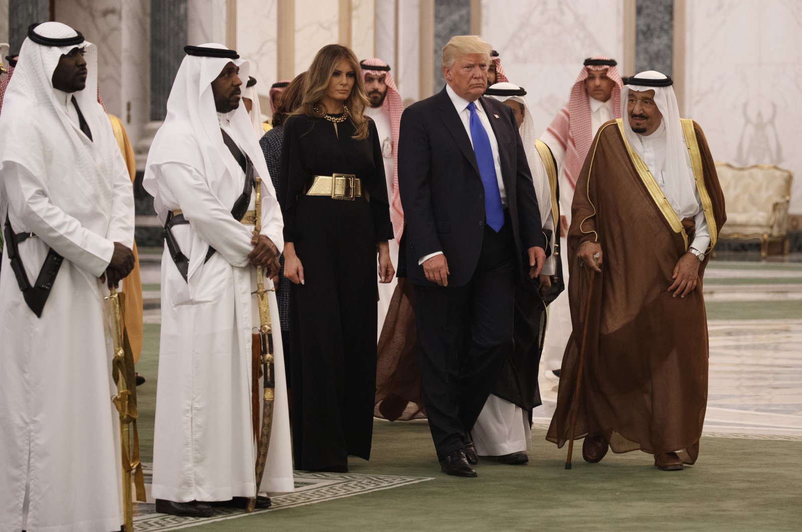 Former U.S. President Donald Trump and first lady Melania Trump walk with Saudi King Salman to a coffee ceremony and presentation ceremony of the Collar of Abdulaziz Al Saud Medal at the Royal Court Palace in Riyadh, Saudi Arabia, May 20, 2017. (AP Photo)