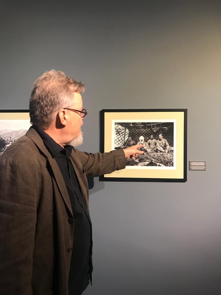 Curator of the exhibition, Peter Sandberg talks about one of Emil Mannerheim's photos at CerModern, Ankara, Turkey, Oct. 12, 2021. (Photo by Dilara Aslan)
