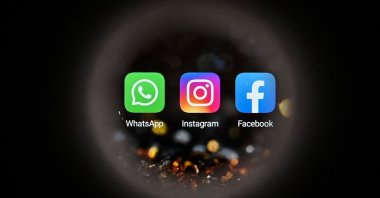 WhatsApp's logo (L), Instagram's logo (C) and Facebook's logo are displayed on a smartphone screen in Moscow, Russia, Oct. 5, 2021. (AFP Photo)