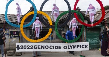 Exiled Tibetans use the Olympic Rings as a prop as they hold a street protest against the holding of 2022 Winter Olympics in Beijing, in Dharmsala, India, Feb. 3, 2021. (AP Photo)
