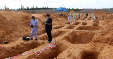 Members of the Government of National Accord's (GNA) missing persons bureau, gather to exhume bodies in a mass grave, in Tarhuna city, Libya, Oct. 27, 2020. (Reuters File Photo)