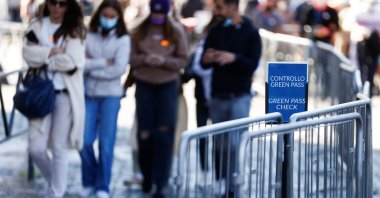 People walk past a sign reading "Green Pass check" as they enter the Colosseum as Italy prepares to become the first European country to make the COVID-19 "Green Pass" mandatory for all workers, Rome, Italy, Oct. 13, 2021. (Reuters Photo)