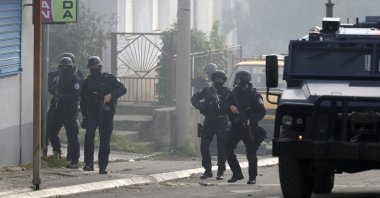 Kosovo police officers guard a street in the northern Serb-dominated part of ethnically divided town of Mitrovica, Kosovo, Oct. 13, 2021. (AP Photo)