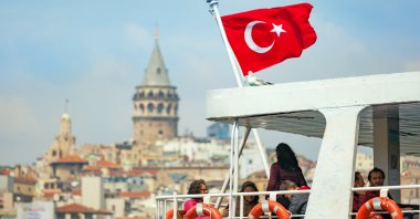 Tourists travel by ferry across the Golden Horn inlet with the famous Galata Tower in the background, Istanbul, Turkey, April 23, 2017. (Shutterstock Photo)