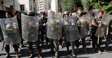 Lebanese troops stand guard near the Justice Palace as supporters of the Hezbollah and Amal groups protest against Judge Tarek Bitar who is investigating last year's deadly seaport blast, Beirut, Lebanon, Oct. 14, 2021. (AP Photo)