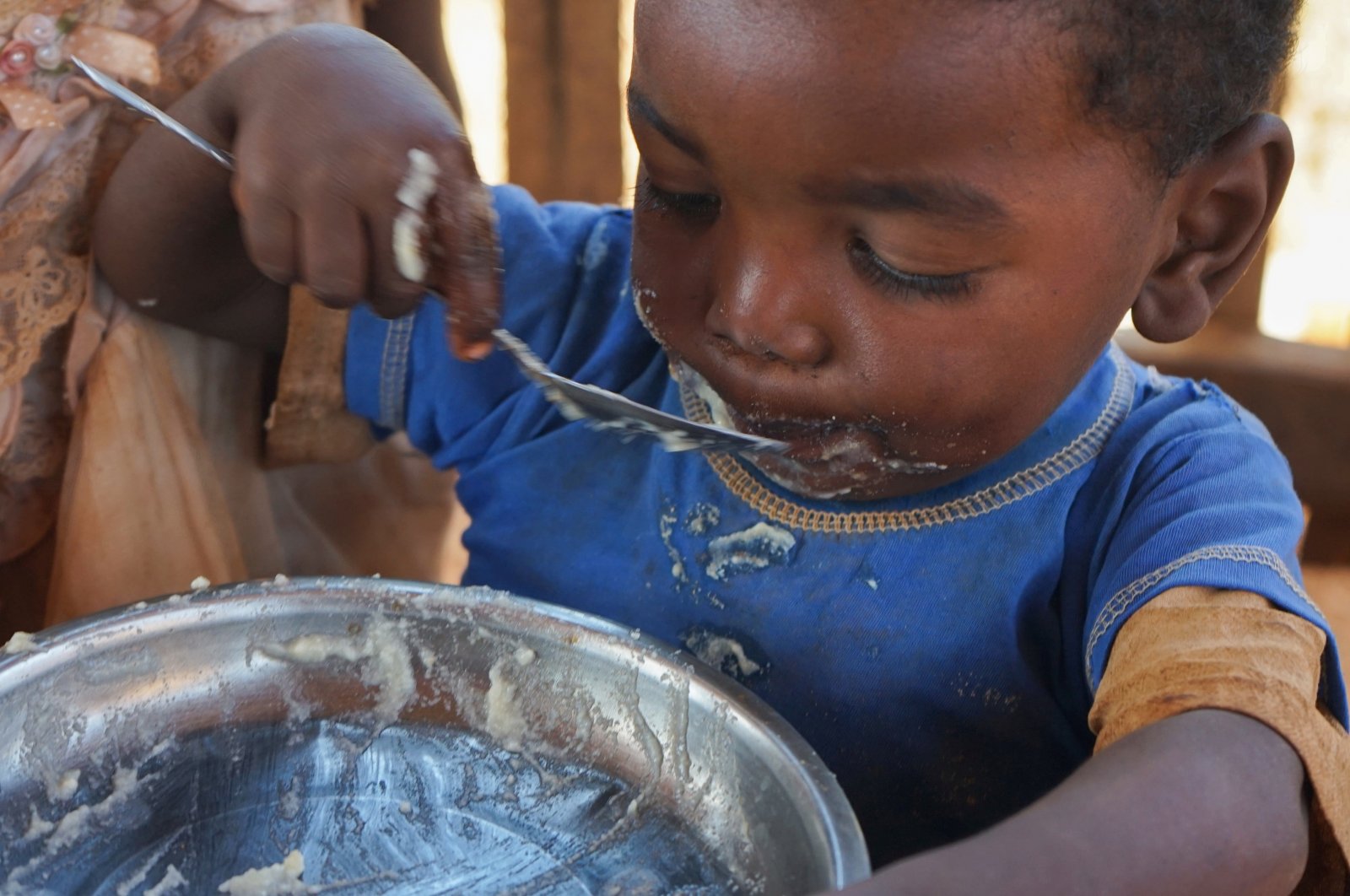 A Malagasy child eats a meal at the Avotse feeding program that benefits malnourished children with hot meals in Maropia Nord village in the region of Anosy, southern Madagascar, Sept. 30, 2021. (Reuters Photo)
