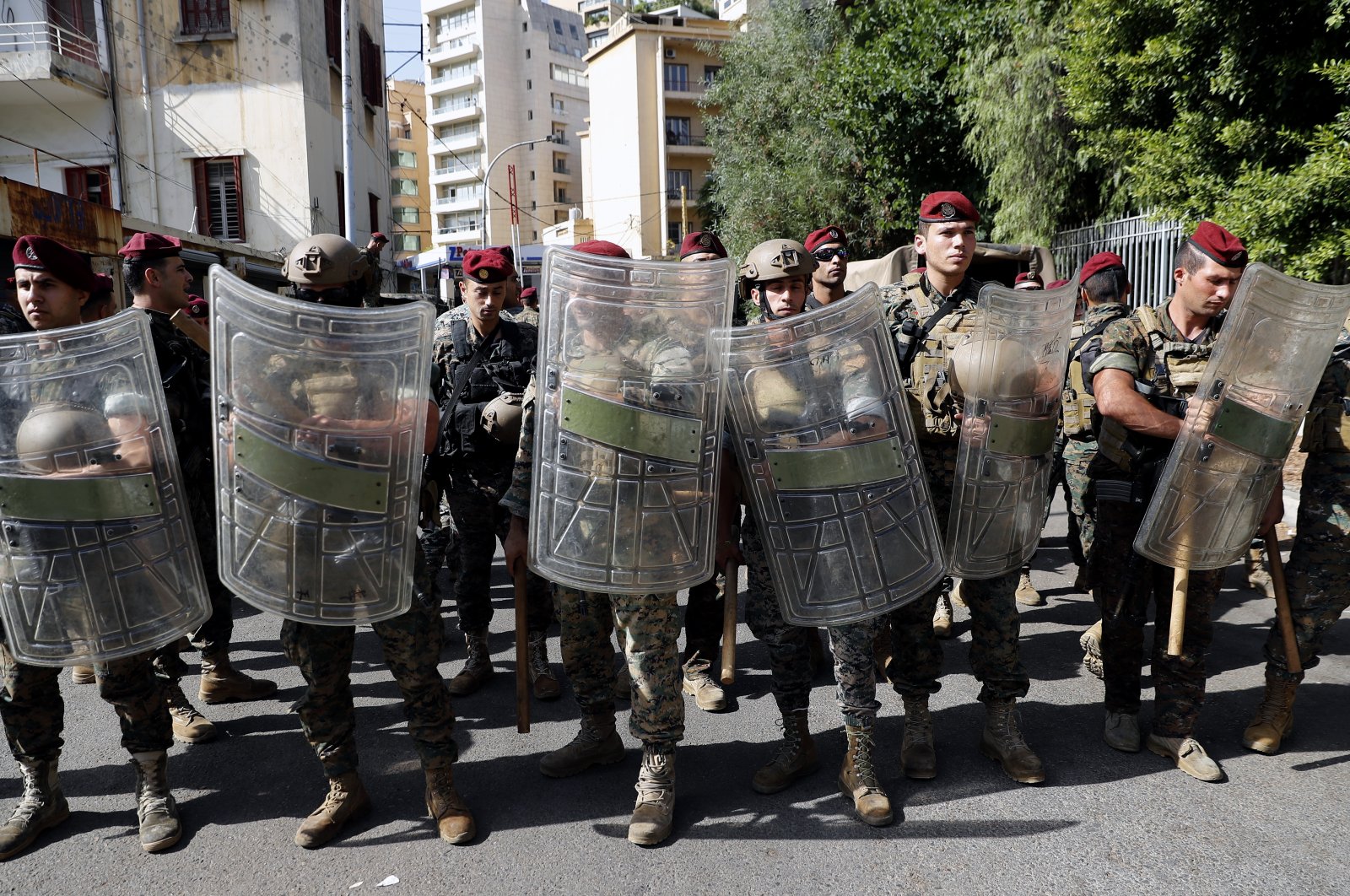 Lebanese troops stand guard near the Justice Palace as supporters of the Hezbollah and Amal groups protest against Judge Tarek Bitar who is investigating last year's deadly seaport blast, Beirut, Lebanon, Oct. 14, 2021. (AP Photo)