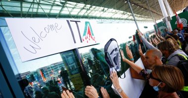 People gather outside Fiumicino airport as Alitalia workers protest against Italia Trasporto Aereo (ITA), as the new airline carrier starts flying in place of bankrupt Alitalia, in Rome, Italy, Oct. 15, 2021. (Reuters Photo)