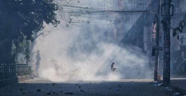 Teargas smoke rises after police clashed with Muslim devotees during a protest over an alleged desecration of the Quran, outside Bangladesh's national mosque Baitul Mukarram, Dhaka, Bangladesh, Oct. 15, 2021. (AP Photo)