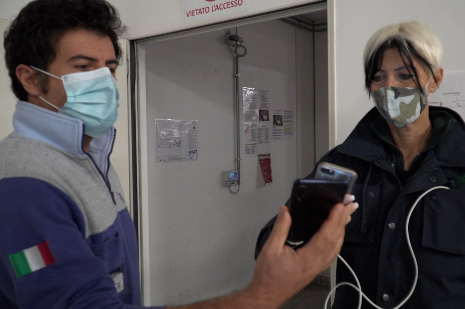 A worker has their Green Pass checked by security as they arrive for their shift at the ISA factory, which has already implemented a health pass obligation for employees ahead of the mandatory requirement in the workplace across Italy from Oct. 15, in this screengrab taken from video, in Bastia Umbria, Italy, Oct. 14, 2021. (Reuters Photo)