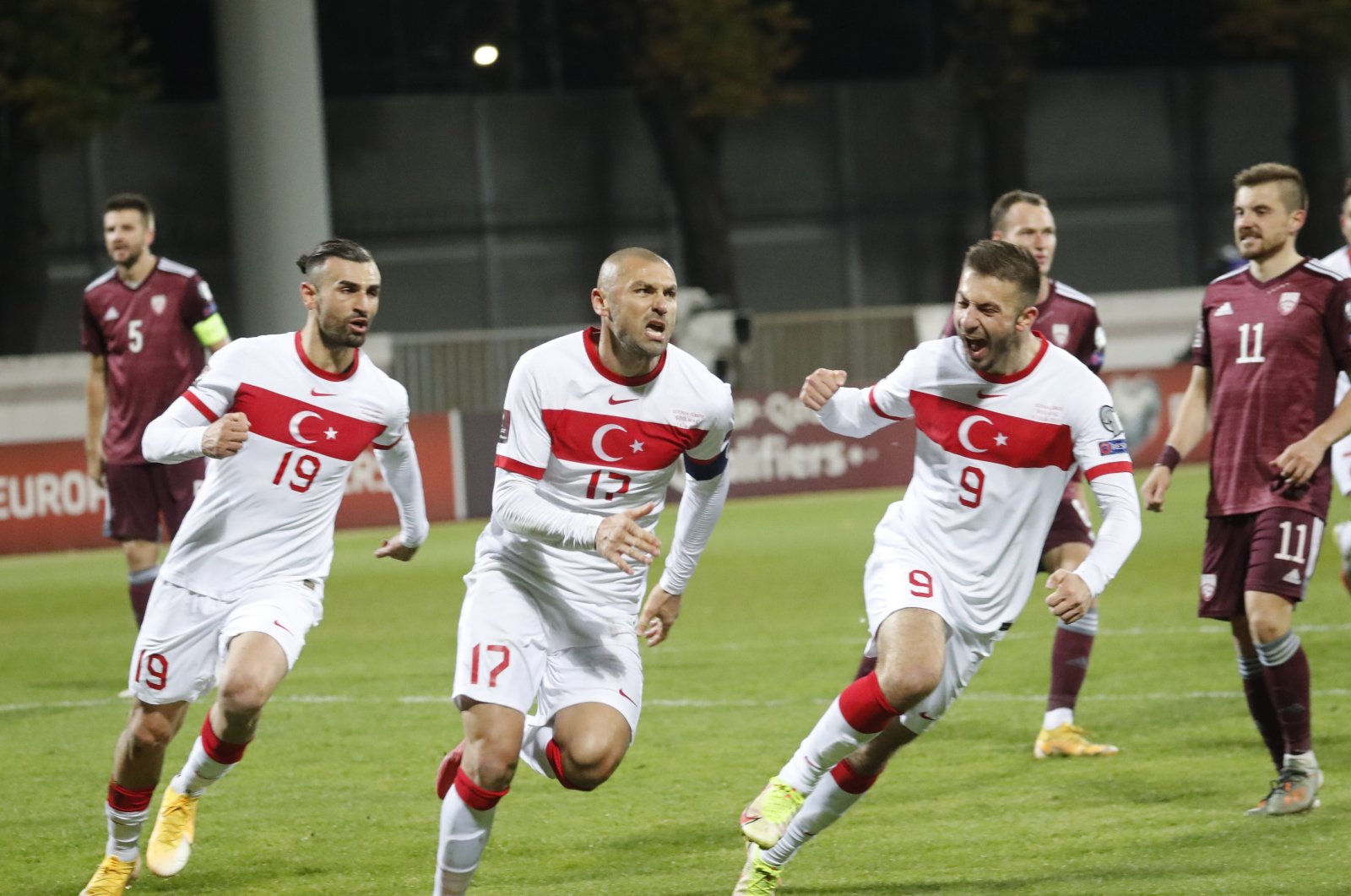 Turkey's Burak Yilmaz (C) celebrates a goal with his teammates Serdar Dursun (L) and Halil Dervişoğlu during a 2022 World Cup qualifiers against Latvia at Daugava Stadium, Riga, Latvia, Oct. 11, 2021. (EPA Photo)