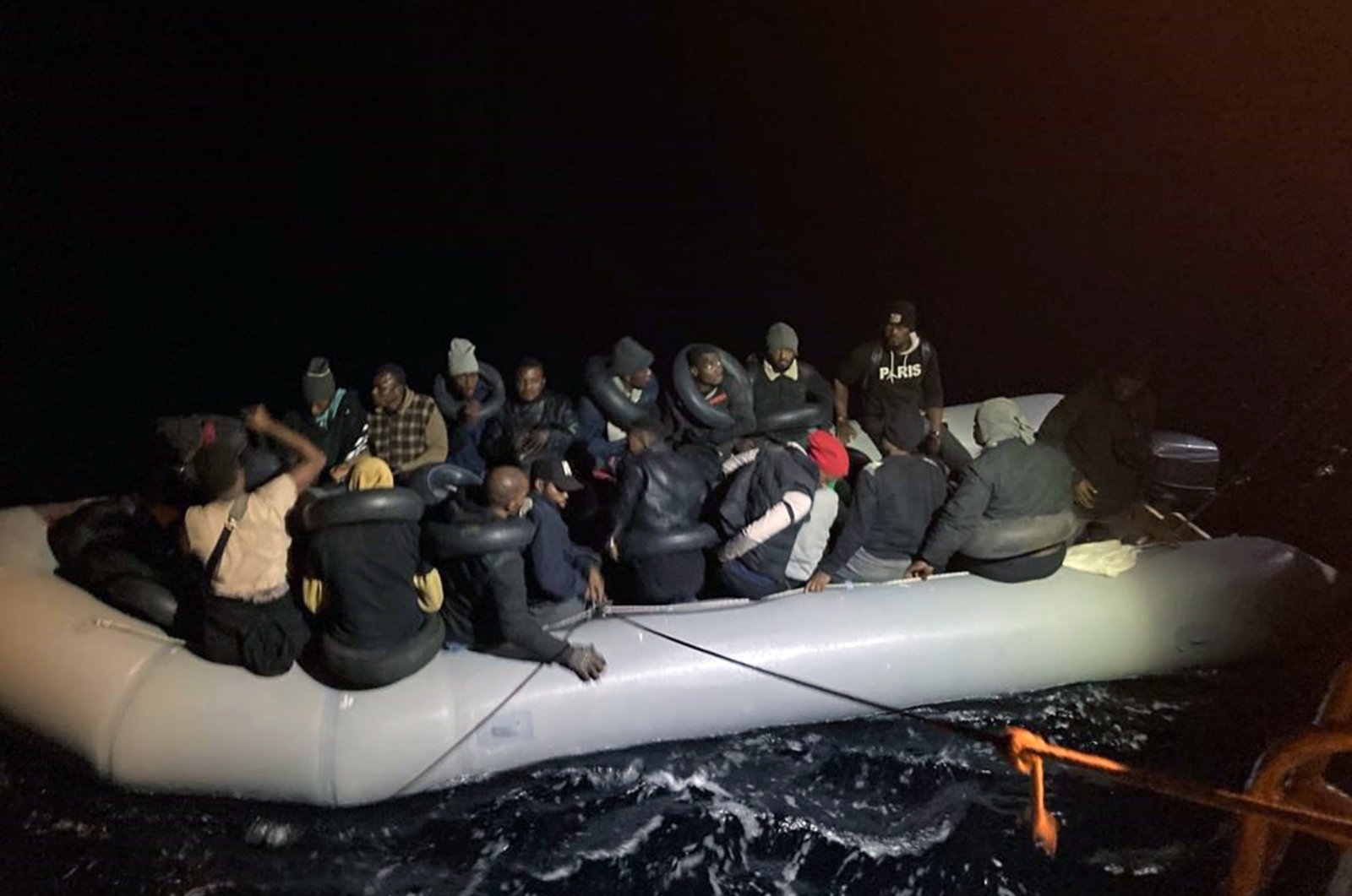 A group of irregular migrants on a rubber boat is rescued off the coast of Fethiye in the Aegean province of Muğla, southwestern Turkey, Oct. 15, 2021. (İHA Photo)