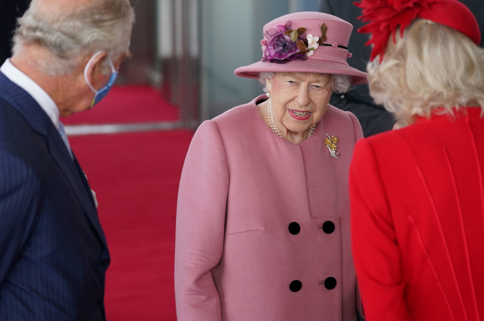 Britain's Queen Elizabeth, accompanied by Prince Charles and Camilla, Duchess of Cornwall, attends the opening ceremony of the sixth session of the Senedd in Cardiff, Britain, Oct. 14, 2021. (REUTERS Photo)
