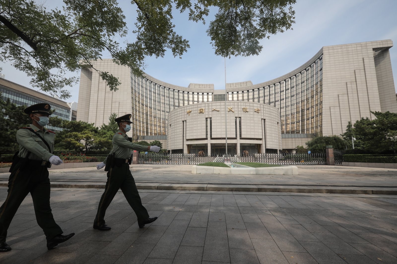 Officers of the People's Armed Police patrol past the headquarters of the People's Bank of China in Beijing, China, Sept. 25, 2021. (EPA Photo)