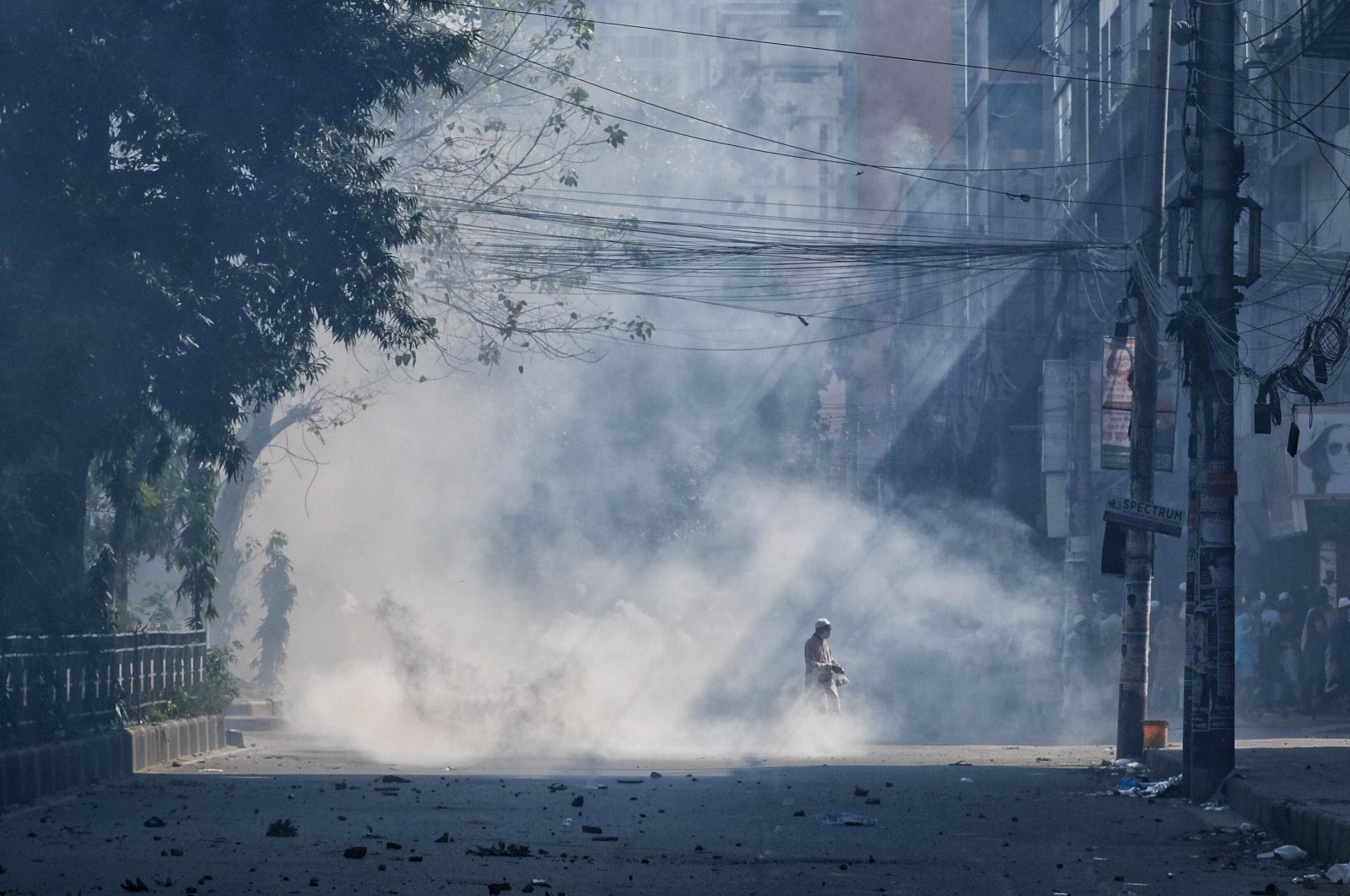 Teargas smoke rises after police clashed with Muslim devotees during a protest over an alleged desecration of the Quran, outside Bangladesh's national mosque Baitul Mukarram, Dhaka, Bangladesh, Oct. 15, 2021. (AP Photo)