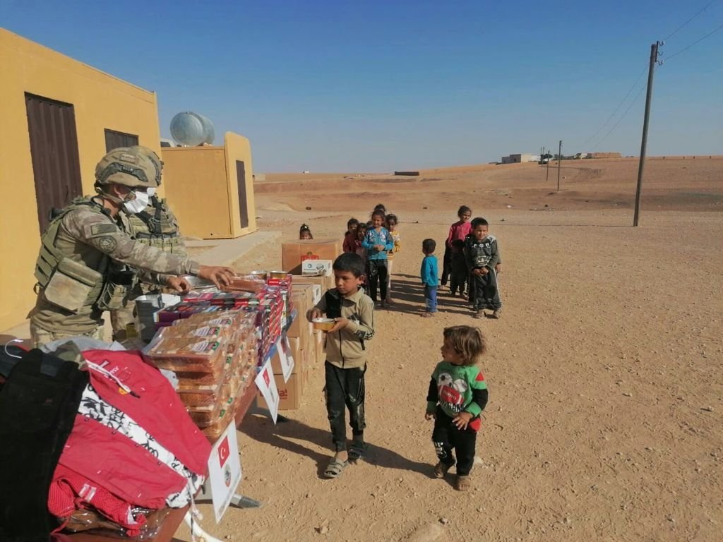Turkish soldiers distribute aid to children in the Operation Peace Spring Zone, northern Syria, Oct. 17, 2021. (AA Photo)