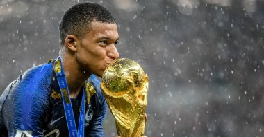 France's Kylian Mbappe kisses the World Cup trophy following the 2018 FIFA World Cup Final between France and Croatia at Luzhniki Stadium in Moscow, Russia, July 15, 2018. (FIFA via Getty Images)
