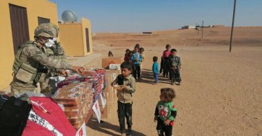 Turkish soldiers distribute aid to children in the Operation Peace Spring Zone, northern Syria, Oct. 17, 2021. (AA Photo)
