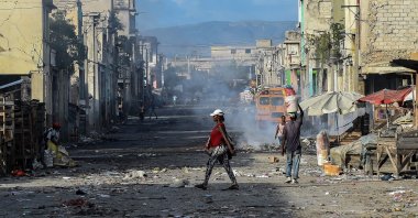 People walk on a deserted road ahead of gang shootings in downtown Port-au-Prince, Haiti, Dec. 20, 2019. (AFP Photo)