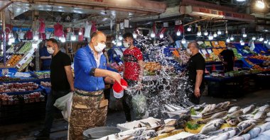 A vendor wears a protective mask at a fish and seafood stall at a local market during a nationwide "full closure" to prevent the spread of the coronavirus disease (COVID-19), in Ankara, Turkey May 7, 2021. (Reuters File Photo)