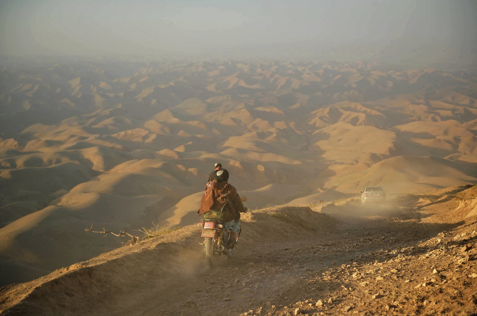 A Taliban member rides his motorbike on a hill in the Morghab district of Badghis province, Afghanistan, Oct. 15, 2021 (AFP Photo)