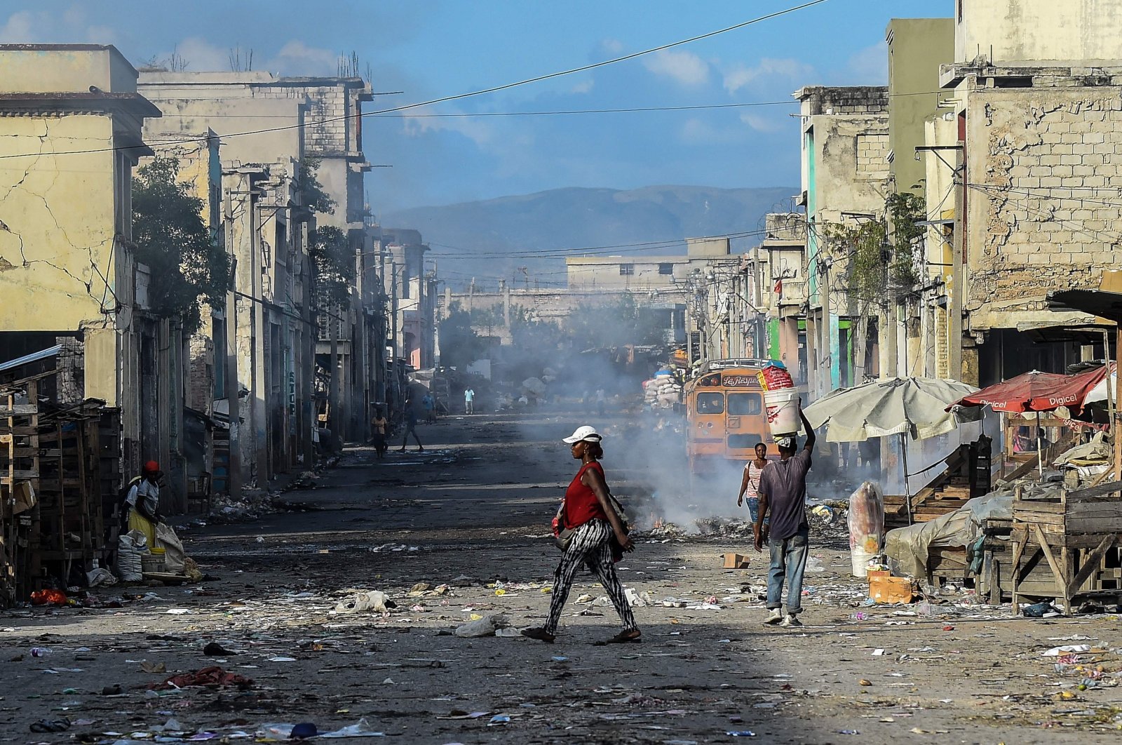 People walk on a deserted road ahead of gang shootings in downtown Port-au-Prince, Haiti, Dec. 20, 2019. (AFP Photo)