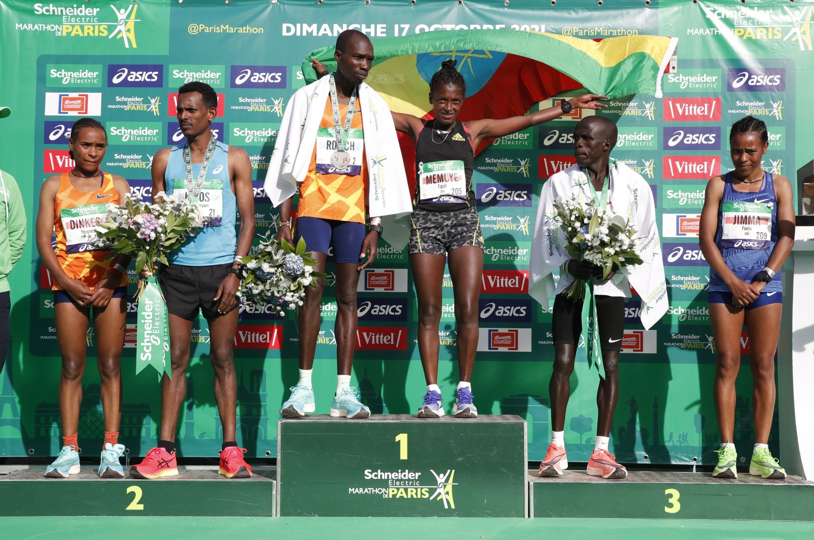 Winners of the Paris Marathon men’s and women’s race, Kenya’s Elisha Rotich (3rd L) and Ethiopia’s Tigist Memuye (C), second-placed Ethiopia’s Hailelmaryam Kiros (L) and Ethiopia’s Yenenesh Dinkesa, and third-placed Kenya’s Hillary Kipsambu and Ethiopia’s Fantu Jimma (R) celebrate on the podium, Paris, France, Oct. 17, 2021. (Reuters Photo)