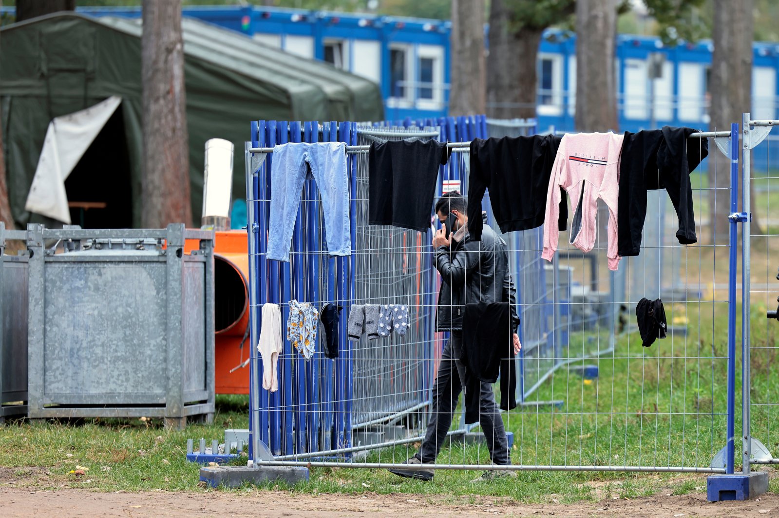 A migrant uses his smartphone in a coronavirus quarantine area at a camp in Eisenhuettenstadt, Germany, Oct. 14, 2021. (Reuters Photo)