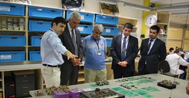 Özdemir Bayraktar (C) with Baykar CEO Haluk Bayraktar (2R), Chief Technology Officer (CTO) Selçuk Bayraktar (1L) and other company employees seen in this undated file photo.