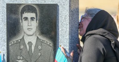 A woman grieves at a cemetery during a commemoration for Azerbaijani service members killed in last year's conflict over the region of Nagorno-Karabakh on its first anniversary, Baku, Azerbaijan, Sept. 27, 2021. (Reuters Photo)