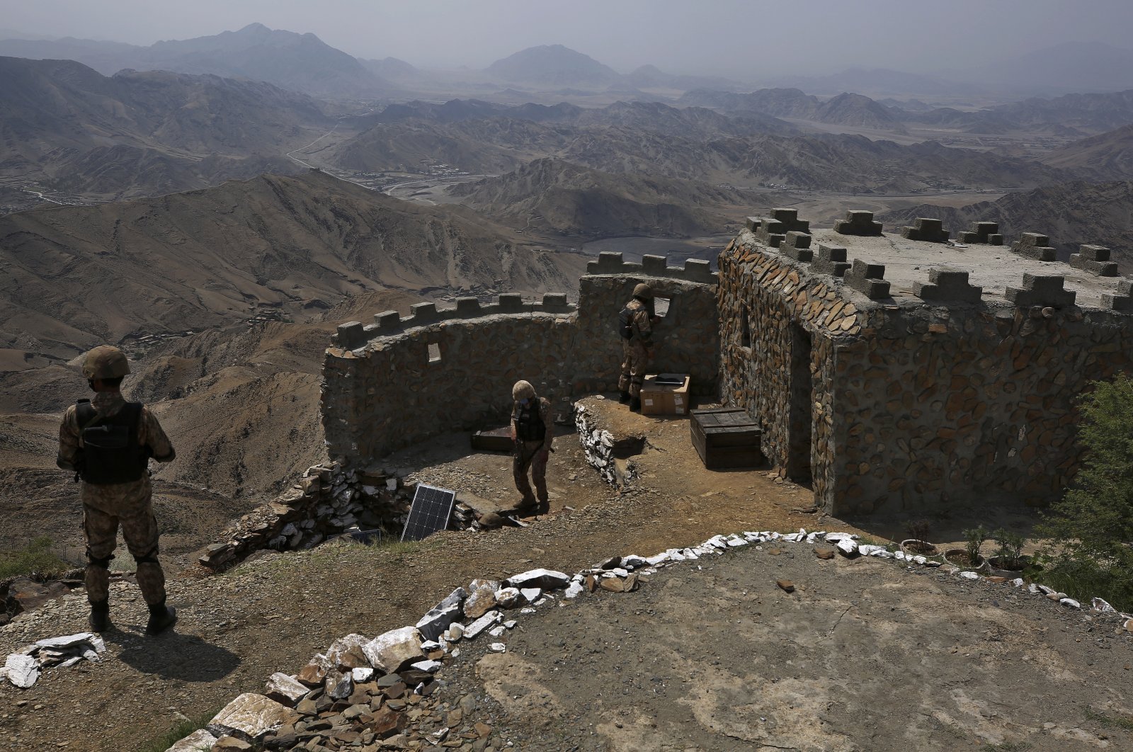 Pakistan Army troops observe the area from hilltop post on the Pakistan Afghanistan border, in Khyber district, Pakistan, Aug. 3, 2021. (AP Photo)