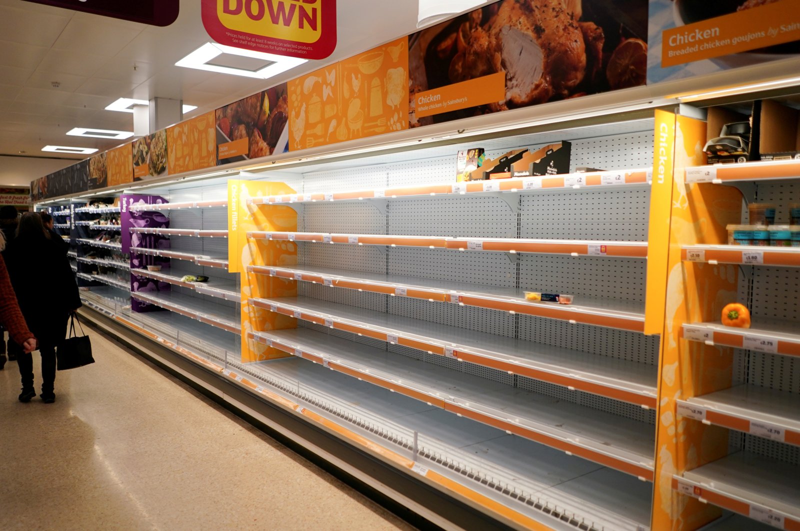 Shelves are left empty of fresh chicken in a supermarket, London, Britain, March 15, 2020. (Reuters Photo)