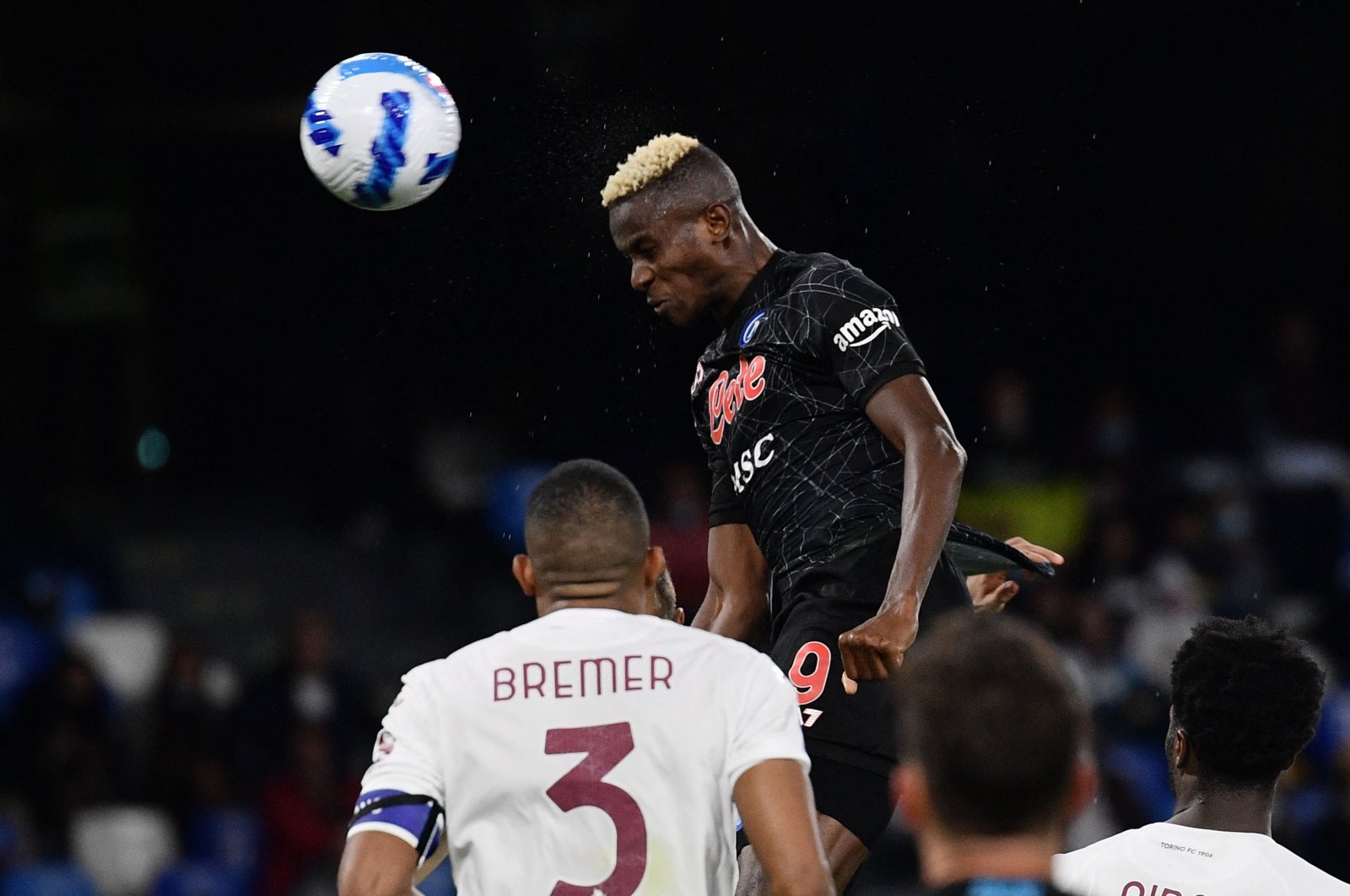 Napoli's Nigerian forward Victor Osimhen scores a header during a Serie A match against Torino at the Diego-Maradona stadium in Naples, Italy, Oct. 17, 2021. (AFP Photo)