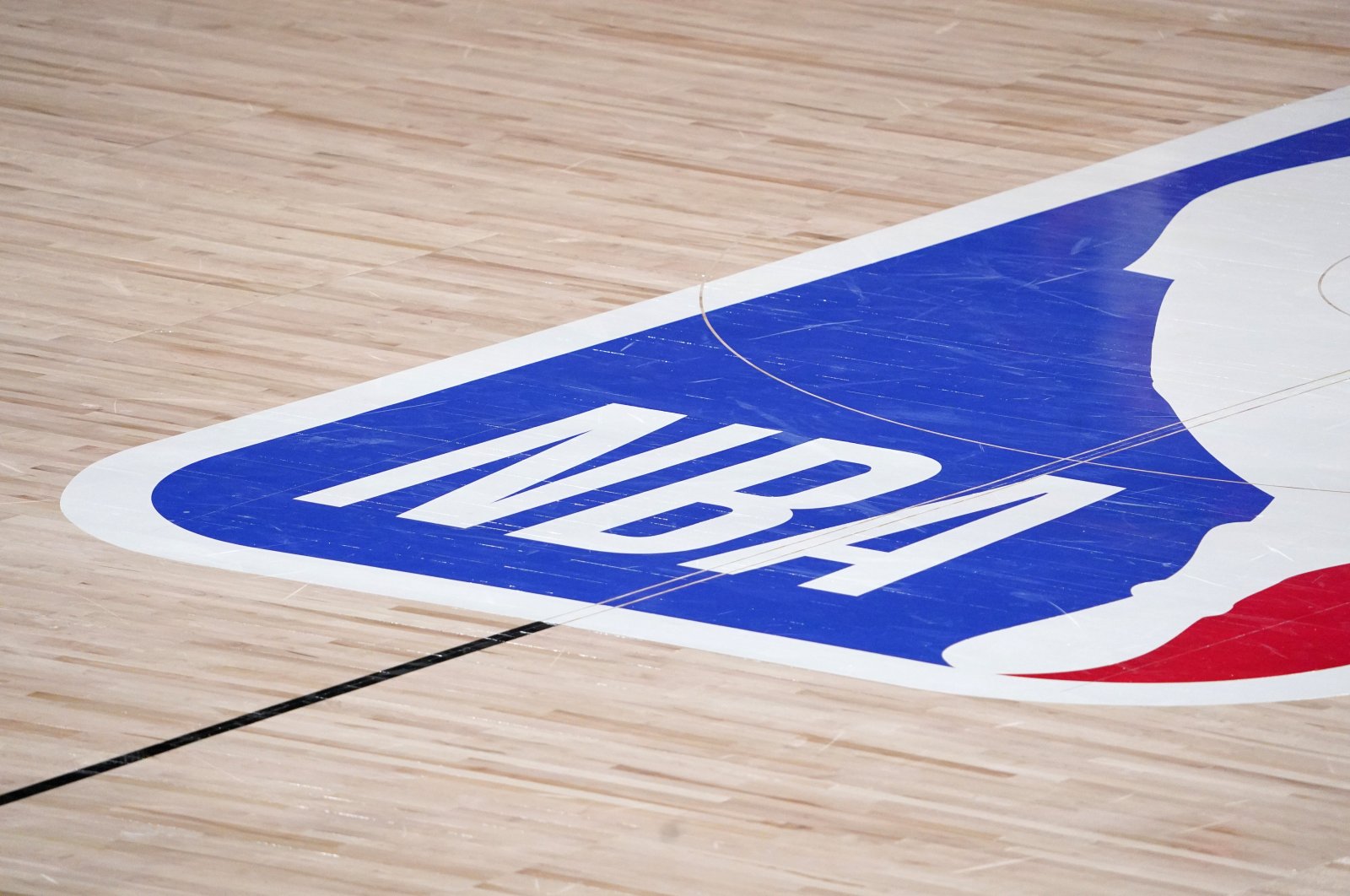 The NBA logo is displayed at the center court during an NBA first-round playoff basketball game between the Houston Rockets and Oklahoma City Thunder in Lake Buena Vista, Florida, U.S., Dec. 1, 2020. (AP Photo)