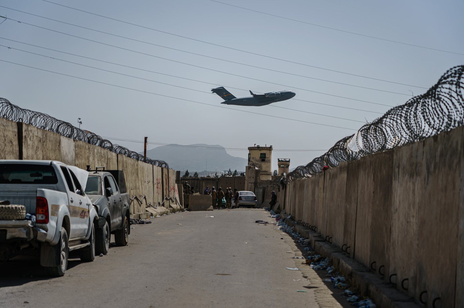 A C-17 Globemaster takes off as Taliban fighters secure the outer perimeter, alongside the American controlled side of of the Hamid Karzai International Airport in Kabul, Afghanistan, Aug. 29, 2021. (Photo by Getty Images)