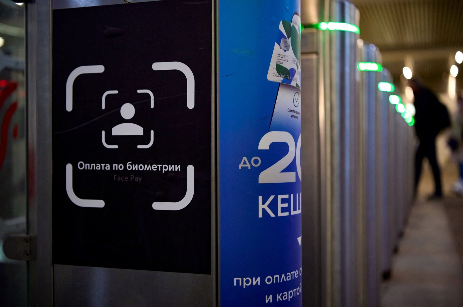 A sign sits on a ticket gate equipped with a facial recognition fare payment system, Face Pay, at Turgenevskaya metro station in Moscow, as the Russian capital tests the new system, Sept. 23, 2021. (AFP Photo)
