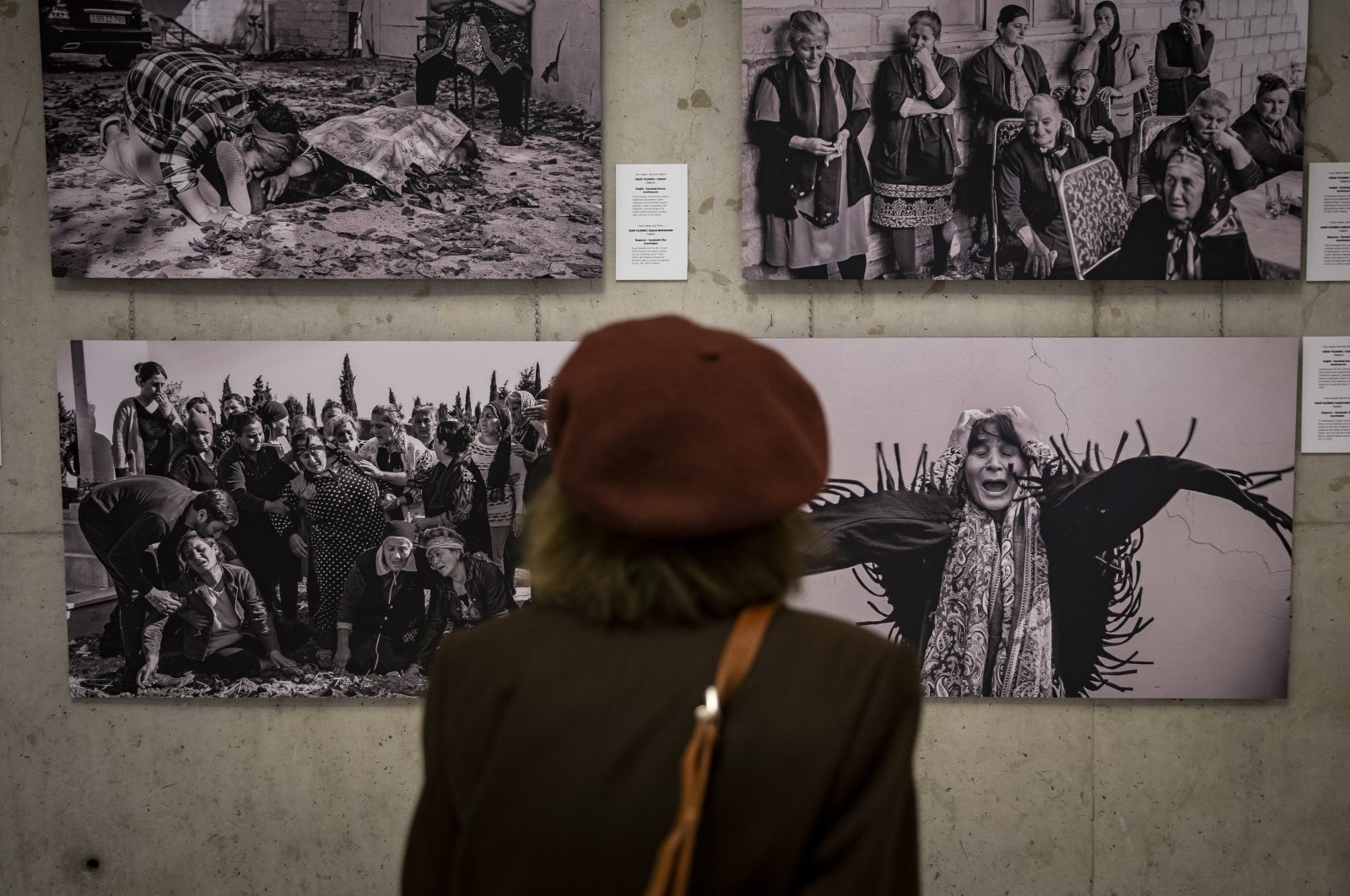 A visitor examines photos at the Istanbul Photo Awards 2021 exhibition in Ankara, Turkey, Oct. 11, 2021. (AA Photo) 