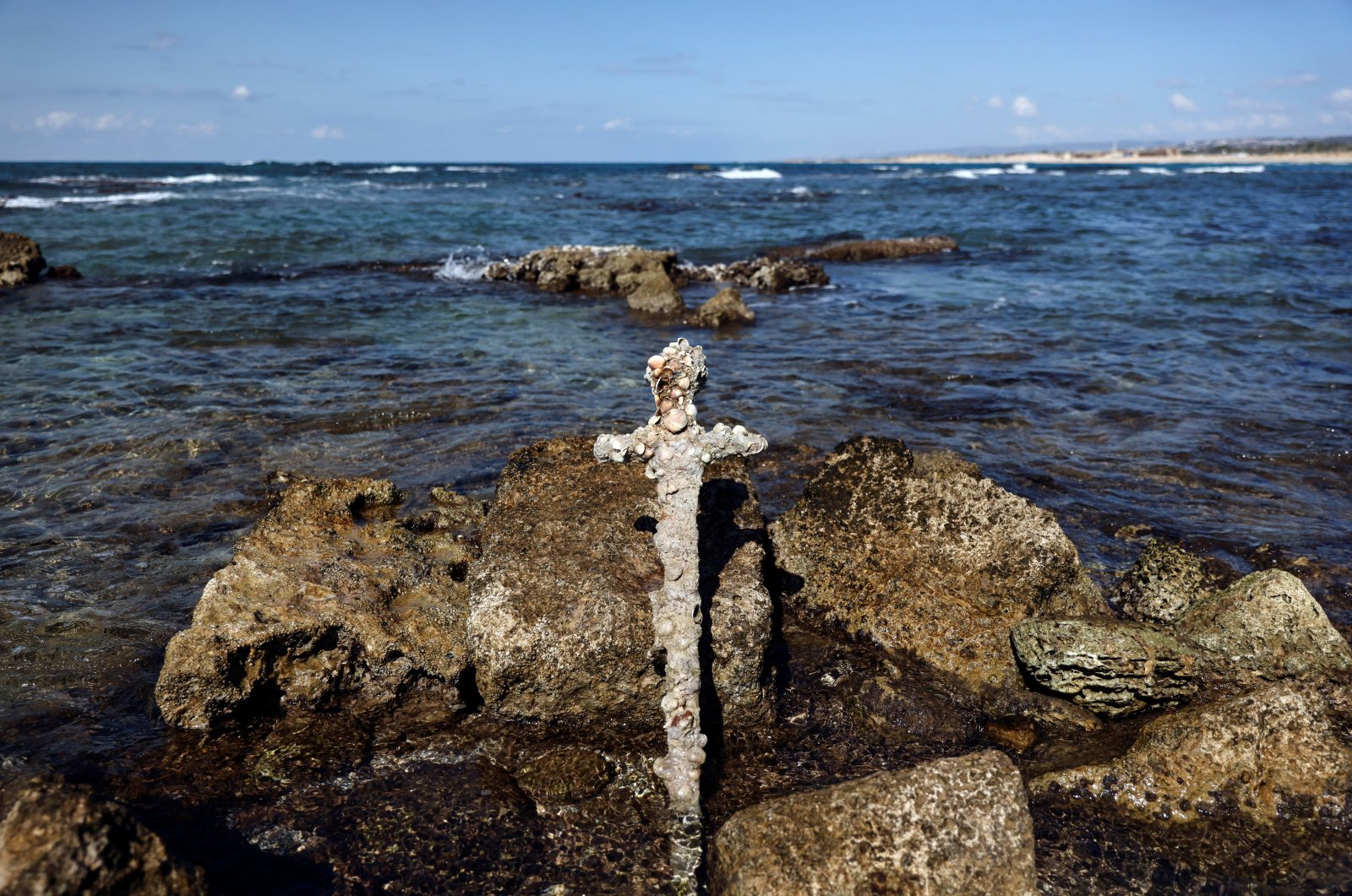 The sword believed to have belonged to a Crusader stands in the water near to where it was recovered from the Mediterranean seabed by an amateur diver, Caesarea, Israel Oct. 18, 2021. (REUTERS Photo)