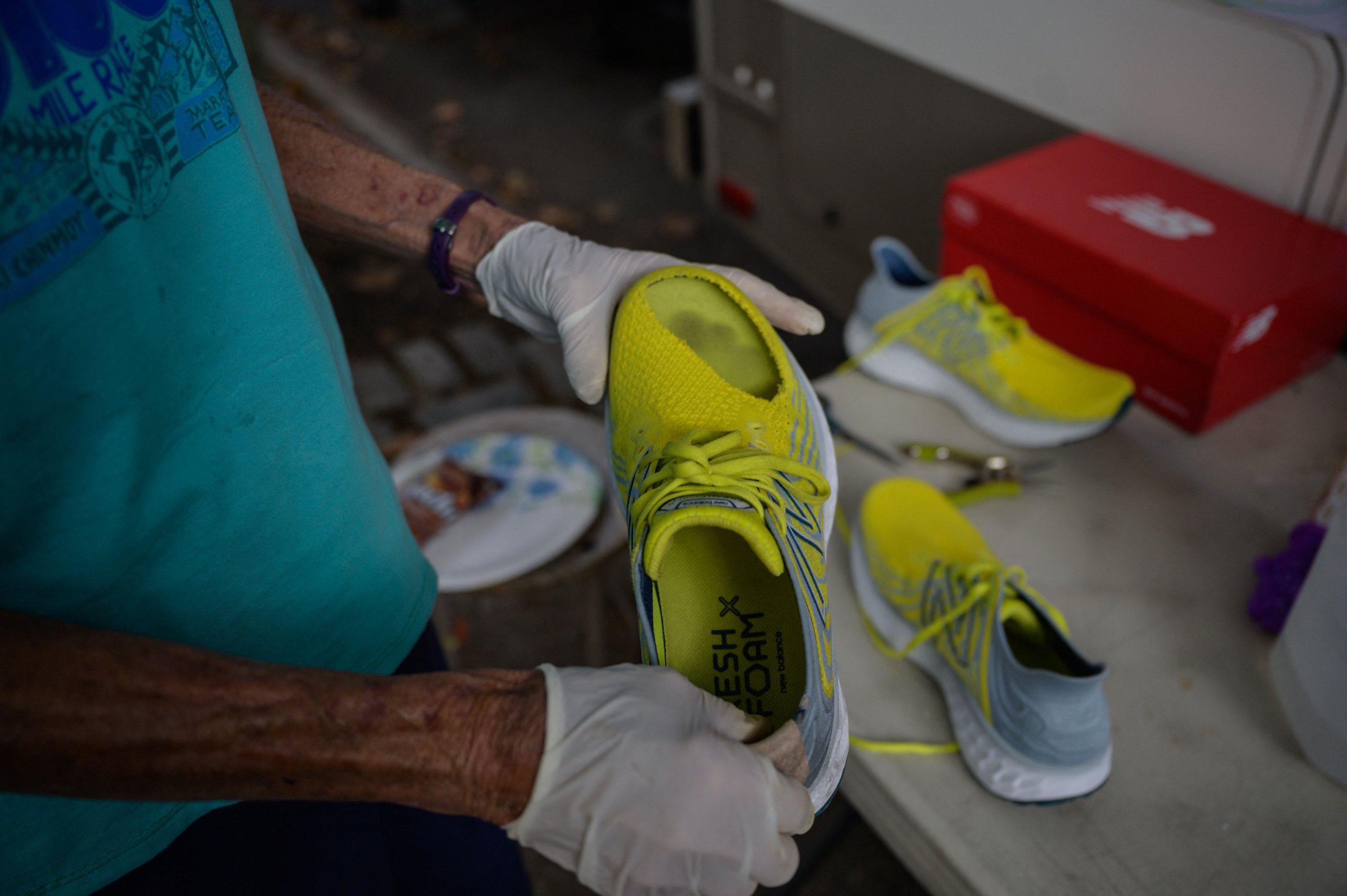 A technician checks the shoes of Harita Davies of New Zealand during the 'Self-Transcendence 3100 Mile Race,' the world's longest certified foot race, in Queens, New York, U.S., Oct. 17, 2021. (AFP Photo)