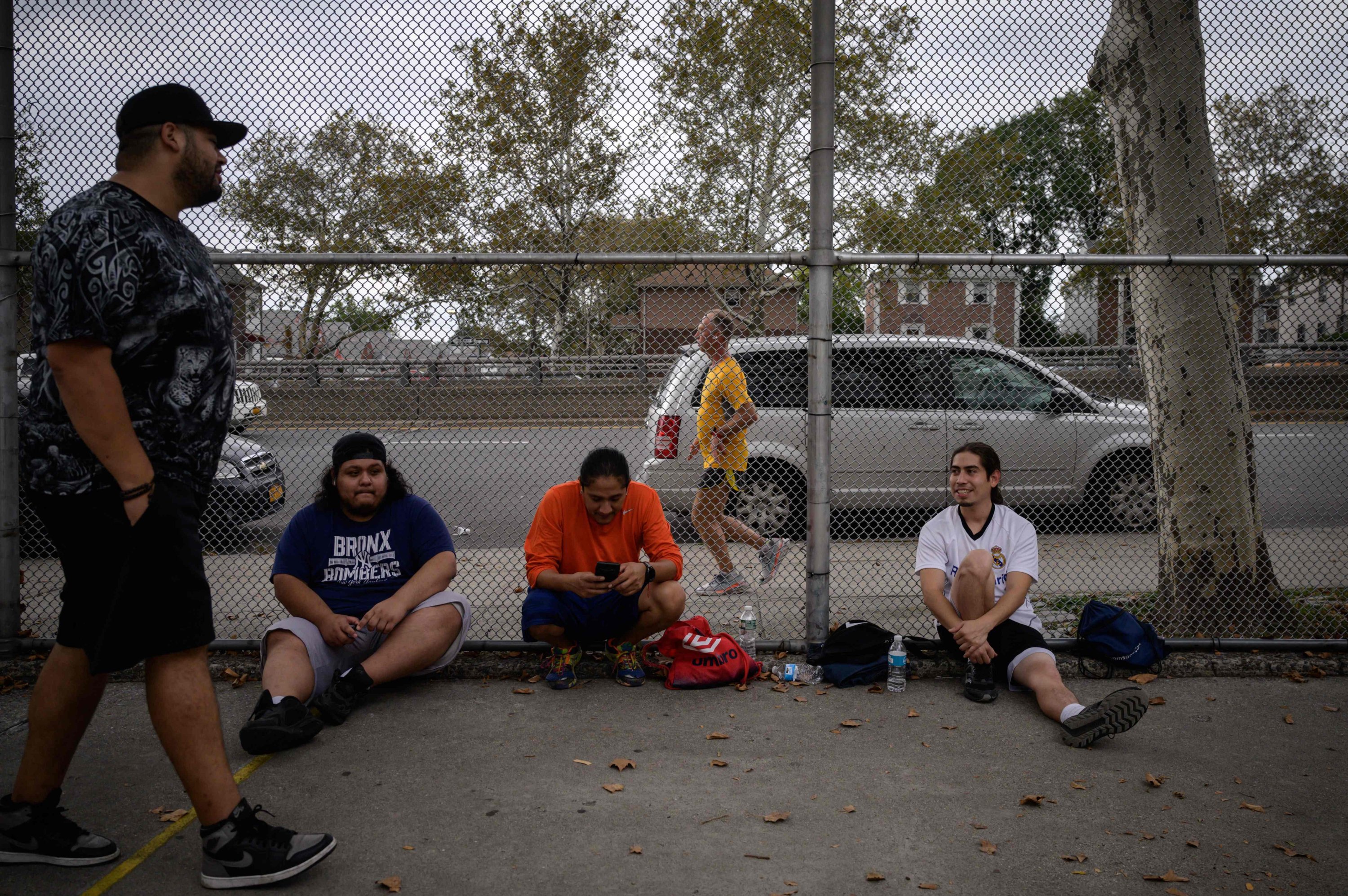 A group of men pause between games on a handball court as Stutisheel Lebedyev (C) of Ukraine competes in the 'Self-Transcendence 3100 Mile Race,' the world's longest certified foot race in Queens, New York, U.S., Oct. 17, 2021. (AFP Photo)