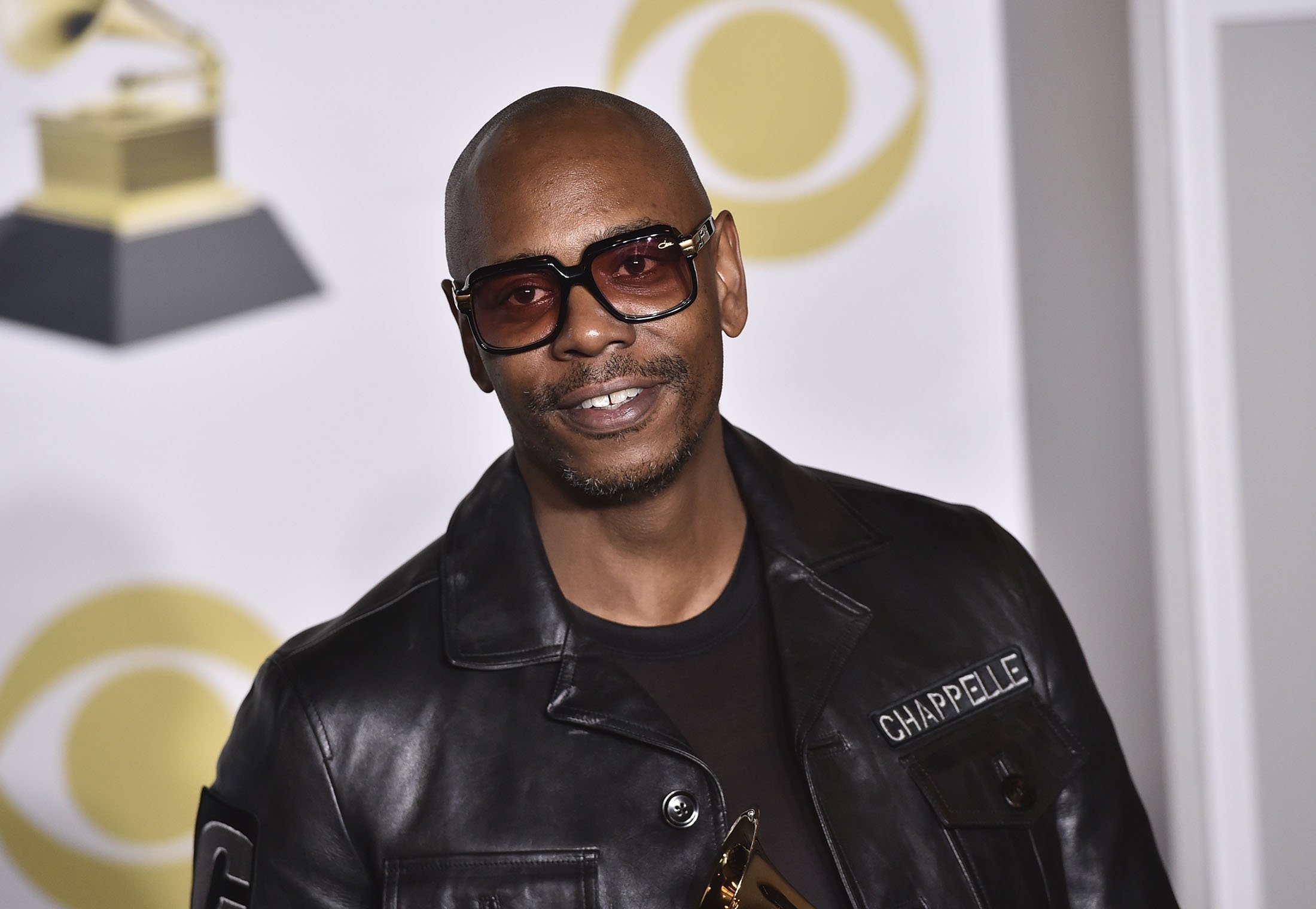Dave Chappelle poses in the press room with the best comedy album award for 'The Age of Spin' and 'Deep in the Heart of Texas' at the 60th annual Grammy Awards in New York, U.S., Jan. 28, 2018. (AP Photo)